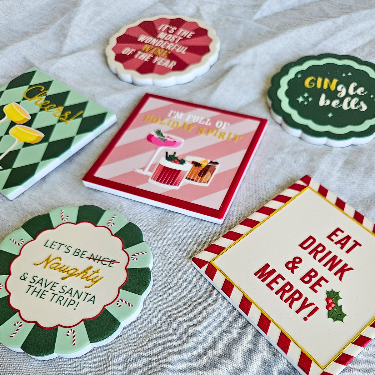 Close-up of the six Christmas Cocktail ceramic coasters with mixed round, scalloped and square designs
