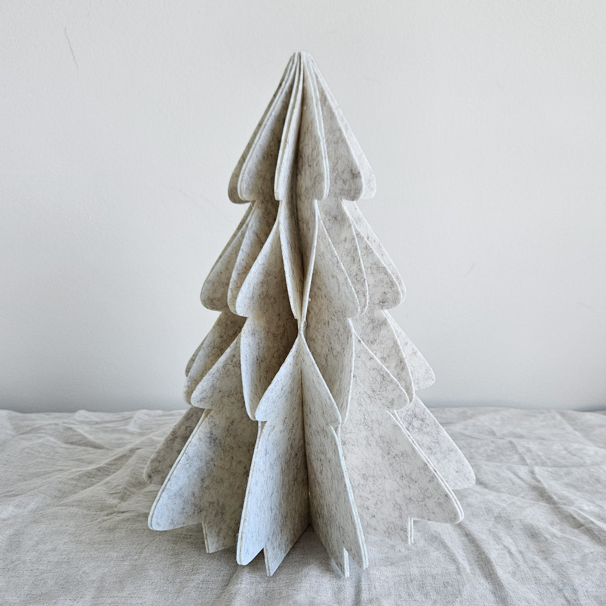 Ivory felt tabletop Christmas tree with a layered three-dimensional silhouette